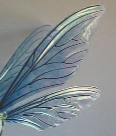 a glass sculpture of a blue bird with long wings