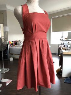 a mannequin wearing a red dress in a room