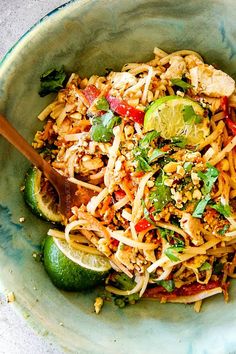 a green bowl filled with noodles and vegetables