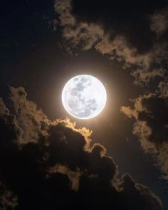 the full moon is shining brightly in the night sky with dark clouds and stars around it