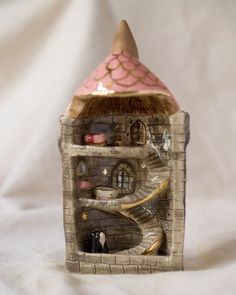 a small doll house made out of clay