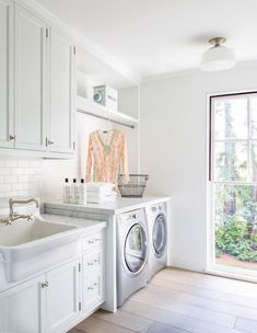 a washer and dryer in a white kitchen