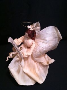 a figurine is holding a knife and wearing a dress with ruffles