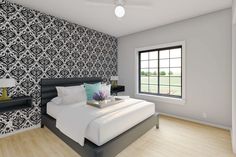 a bedroom with a large bed and black and white wallpaper on the walls next to a window