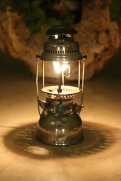 a small metal lantern sitting on top of a table