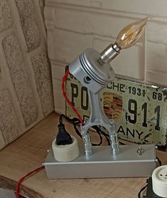 an old style lamp is sitting on top of a table next to some other items