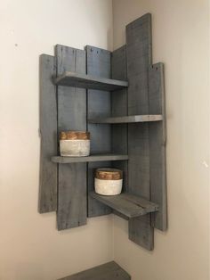 a wooden shelf with two bowls on it and some shelves in the wall behind it