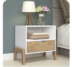 a night stand with two drawers and a lamp next to it