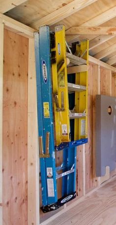 the inside of a house being built with wooden walls and beams, including ladders