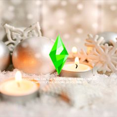 christmas decorations and candles on snow covered ground