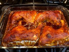 some food that is in a glass dish on the oven burner and ready to be cooked