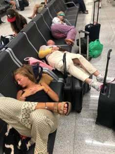 people are sleeping on their luggage at the airport