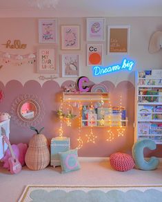 a child's bedroom decorated in pink, blue and white with lots of lights