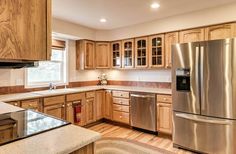 a kitchen with wooden cabinets and stainless steel appliances