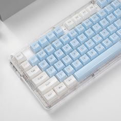 a blue and white keyboard sitting on top of a table