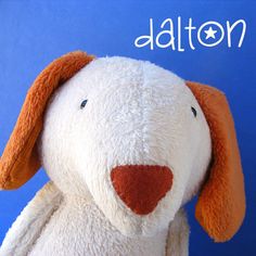 a close up of a stuffed animal on a blue background with the word dalton written above it