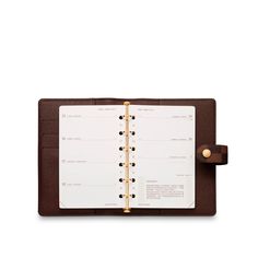 a brown and white planner with gold trim