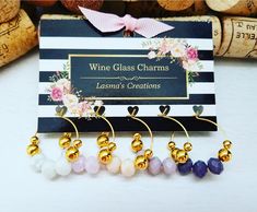 three wine glass charms are sitting next to each other on a card with the words wine glass charms written in gold