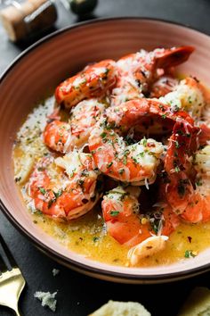 a bowl filled with shrimp and grits on top of a table