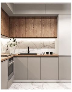 a modern kitchen with marble counter tops and wooden cabinetry, along with white walls