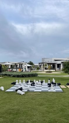 a giant chess set in the middle of a lawn