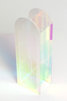 This iridescent arch vase will transform your flowers into an artistic endeavor. Place near a window to let the light create colorful reflections to enhance your arrangements or style as a standalone piece on your favorite shelf. Modern arch shape Iridescent acrylic Multi-use (vase or décor) Arch Vase, Acrylic Arch, Iridescent Acrylic, Chairs And Ottomans, Shelf Modern, Apartment Things, Arch Shape, Vintage Trends, Acrylic Decor