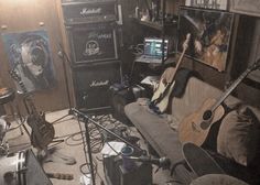 a living room filled with guitars and other musical equipment