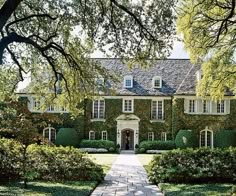 a large house with lots of trees and bushes around it