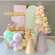 a table topped with lots of balloons and desserts