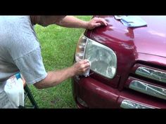 a man waxing the hood of a red truck