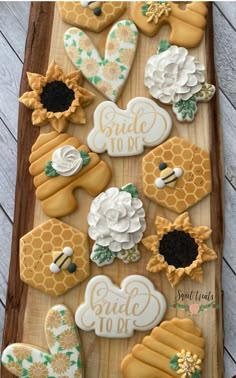 decorated cookies on a wooden tray with flowers and beehives in the middle