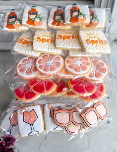 some cookies are sitting on top of plastic wrappers with oranges and sunglasses on them