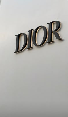 the word dior is written in gold and black