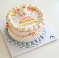 a birthday cake decorated with white frosting and colorful sprinkles