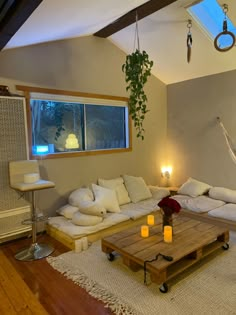 a living room filled with furniture and a hammock hanging from the ceiling