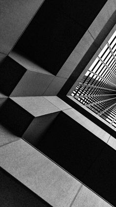 a black and white photo of the ceiling in an office building with geometric designs on it