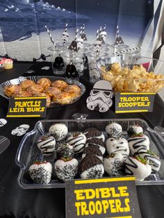 star wars themed desserts and snacks are on display at a party for the force awake