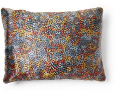 an orange and blue pillow on a white background