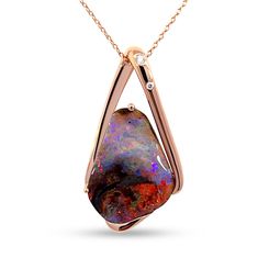 Exuding elegance and sophistication, this 'Amour Eternal'  pendant showcases a mesmerizing play-of-color with a hint of captivating reds that dance with each movement. Set in luxurious 18k rose gold, it exudes refined opulence.  More than an addition to your collection, it's a symbol of cherished moments and meaningful bonds.  #AmourEternal #OpalTales #RenataBernardDesigns #OpalMagic #CherishedConnections #OpalShop #OpalStore #OpalSydney #GiftOfLove #OpalWonder Gold Opal Jewelry, Australian Opal Ring, Boulder Opal Pendant, Unique Opal, Opal Pendant Necklace, Australian Boulder Opal, Ethical Jewelry, Opal Bracelet, Old Jewelry