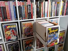 a bookshelf filled with comic books and comics on top of each bookcase