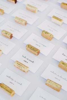 there are many different types of wine corks on the white tablecloth that is laid out