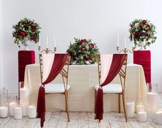 the table is set up with red and white linens for an elegant wedding reception