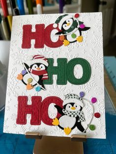 a handmade card with penguins and the words ho hoo written in large letters