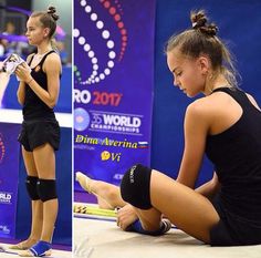 a woman sitting on the ground with her legs crossed and holding a tennis racquet