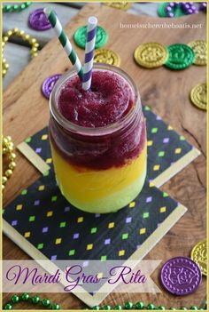 a jar filled with liquid sitting on top of a wooden table next to some cookies