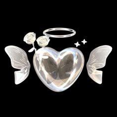 two angel wings and a heart shaped object on a black background with stars around it