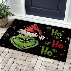 the grinch door mat is decorated with santa's hat