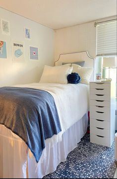 a bedroom with blue and white decor on the walls, bedding and dressers