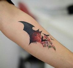 a bat tattoo on the left arm