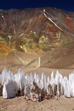 the mountains are covered in snow and ice formations, with rocks sticking out from them